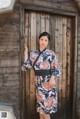 A woman standing in front of a wooden door.