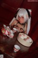 A woman sitting at a table with a bowl of food.